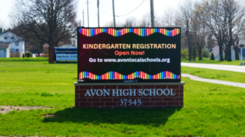 Illuminated digital message center and brick monument sign at Avon High School, installed and serviced by the Brady Signs team, who also handle business sign repair in Avon, OH.